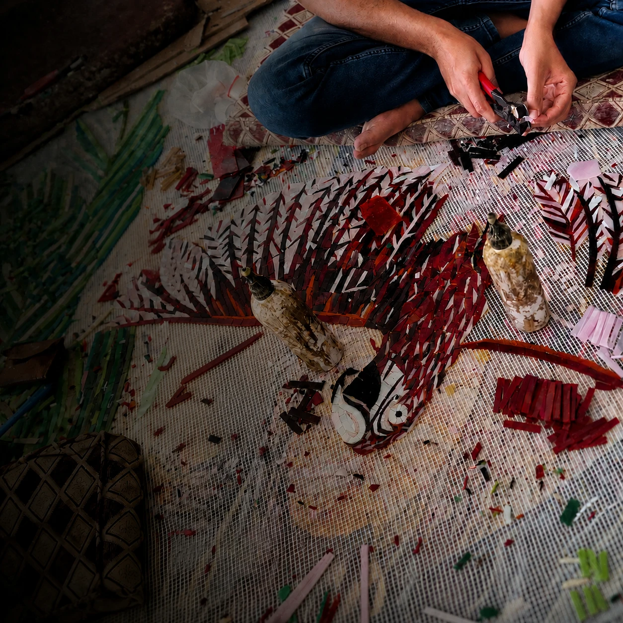 Handcrafting a bespoke mosaic with red and white glass pieces