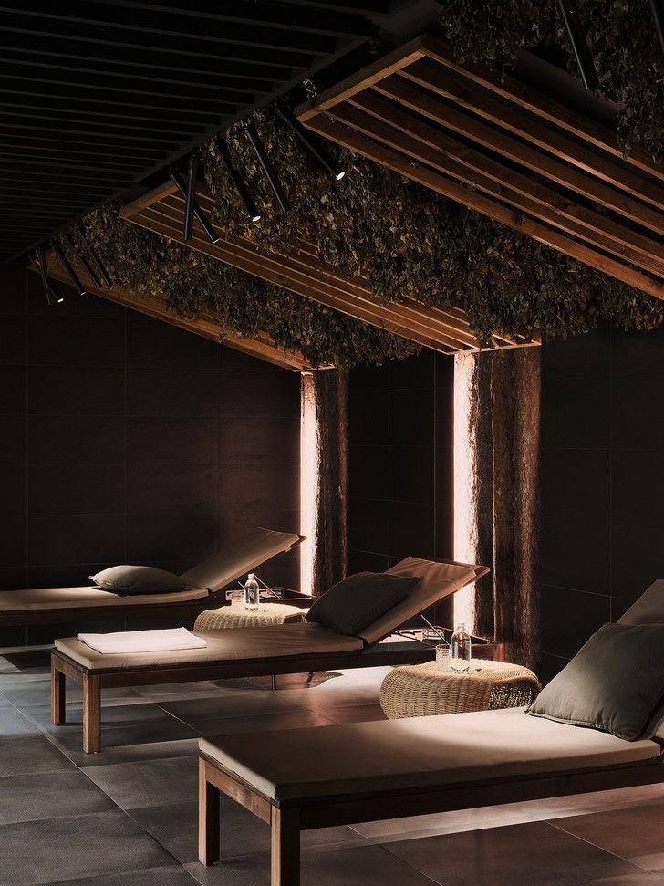 Spa relaxation area with a botanical ceiling and timber loungers